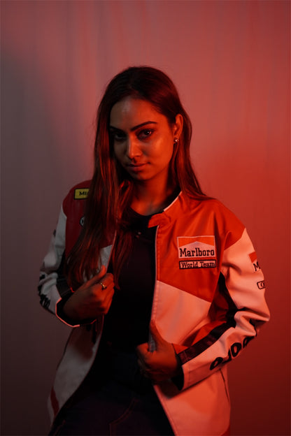 Person wearing a vintage racing suit with visible branding against a red background